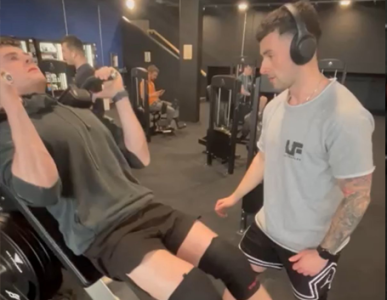 Steven coaching a client through a dumbbell press